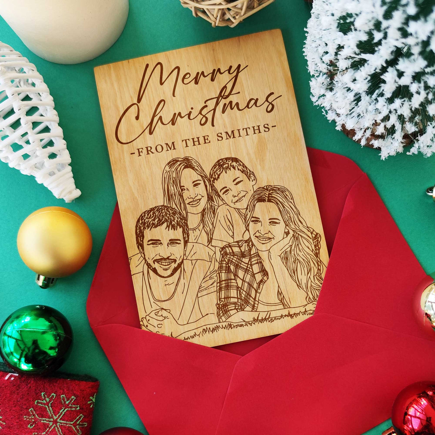 Laser engraved wooden Christmas greeting card with family portrait and red envelope.