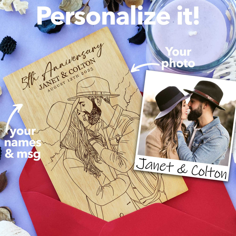 Wooden card with engraved photo beside red envelope 