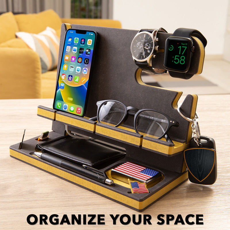 Black engineered wood desk organizer with yellow accents holding personal items in a cozy living room, customizable gift for men